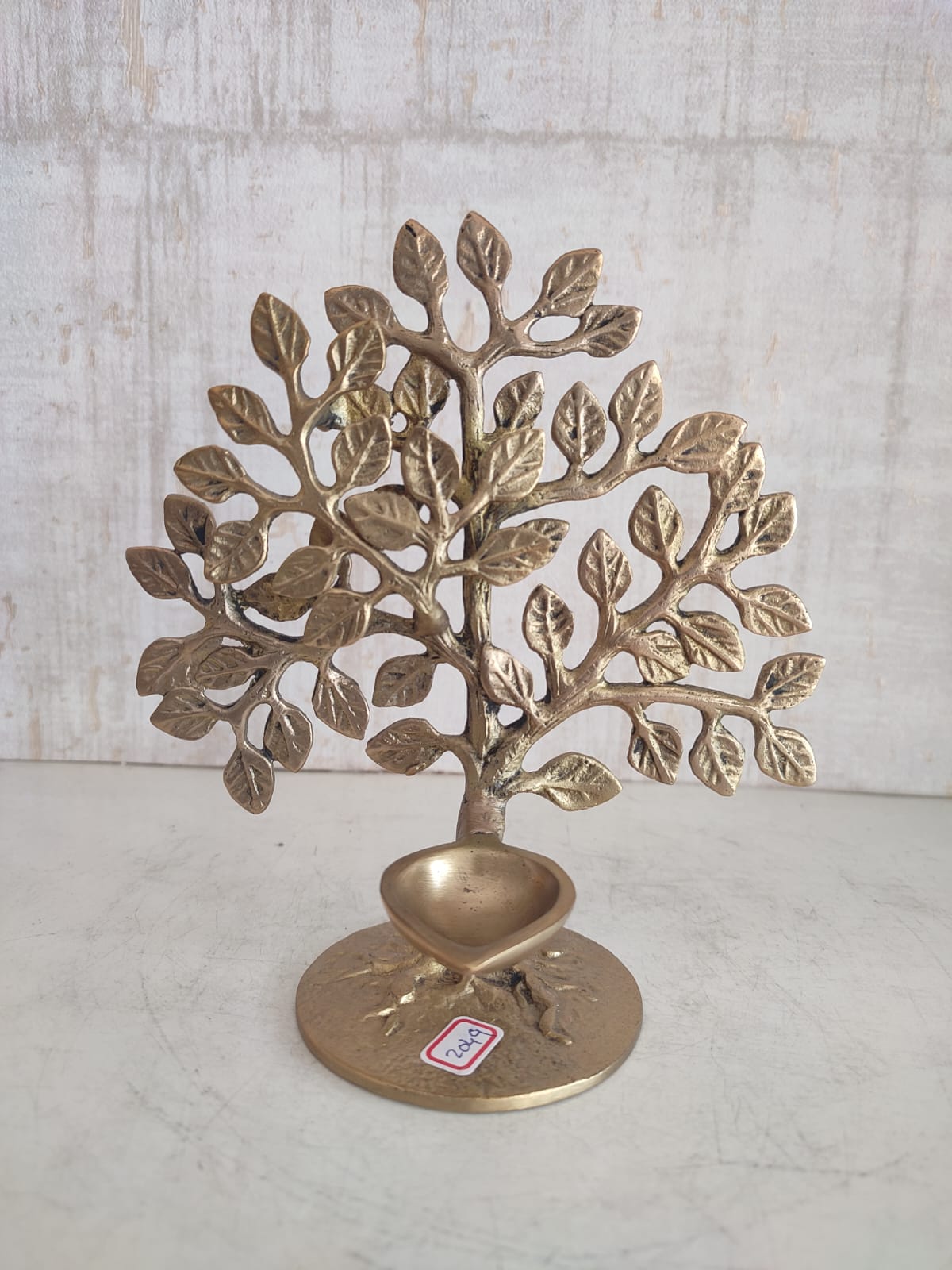 Elegant brass kalpavriksha with diya home accent decor piece showcasing intricate detailing and traditional design.