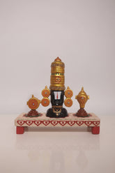 Lord Venkateswara wooden altar with golden crown, conch, and chakra wheels on a decorated base