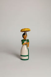 Traditional Etikoppaka wooden doll with umbrella, a charming home decor piece.