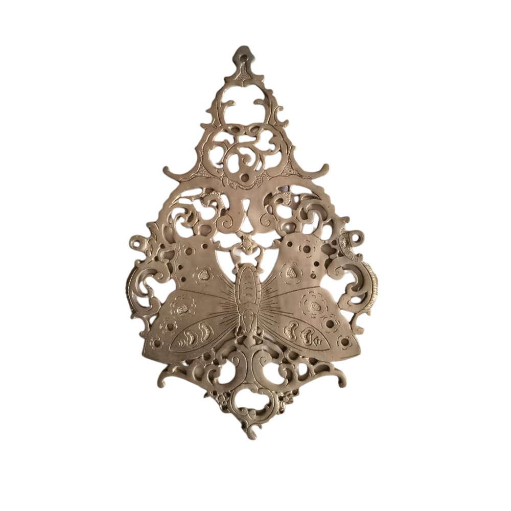 Vintage brass butterfly wall decor with intricate filigree medallion design.