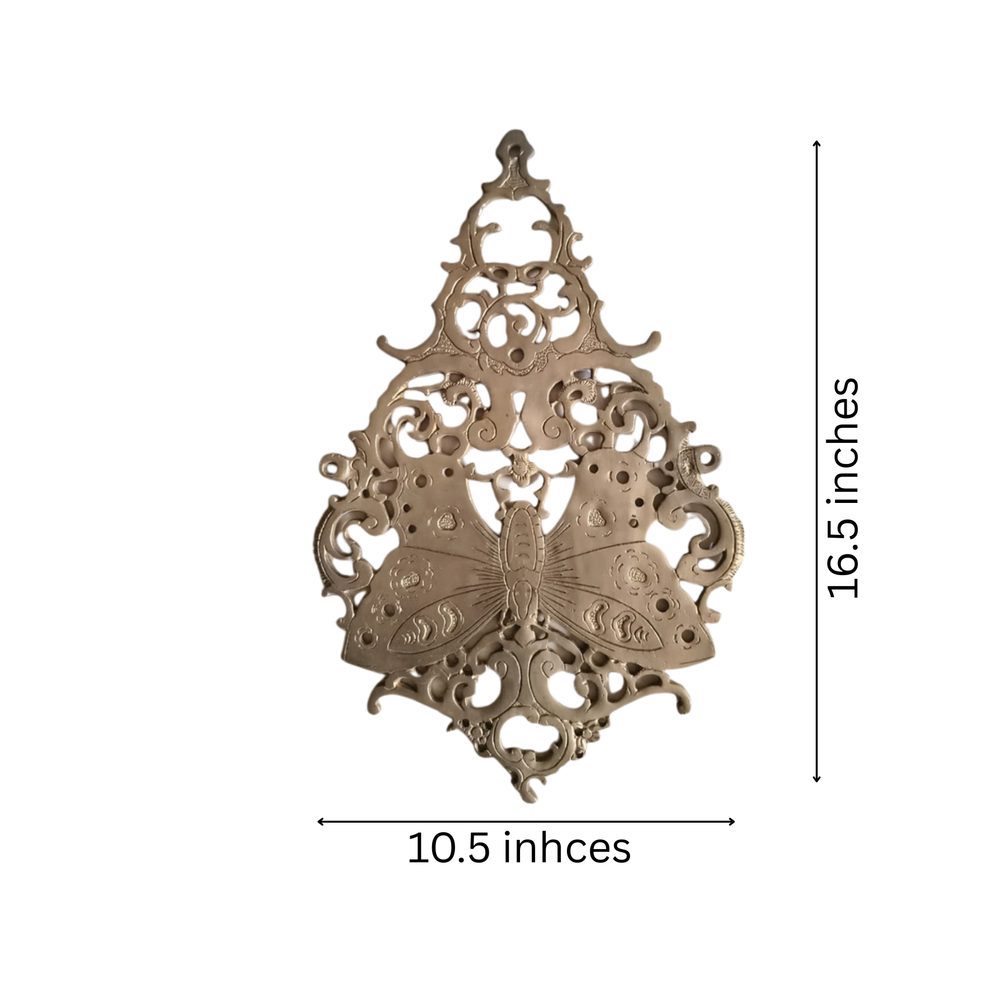 Vintage brass butterfly wall decor with intricate filigree detailing.