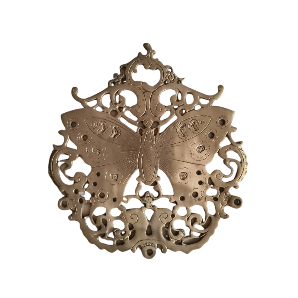 Vintage-style brass butterfly wall decor with intricate filigree medallion design.