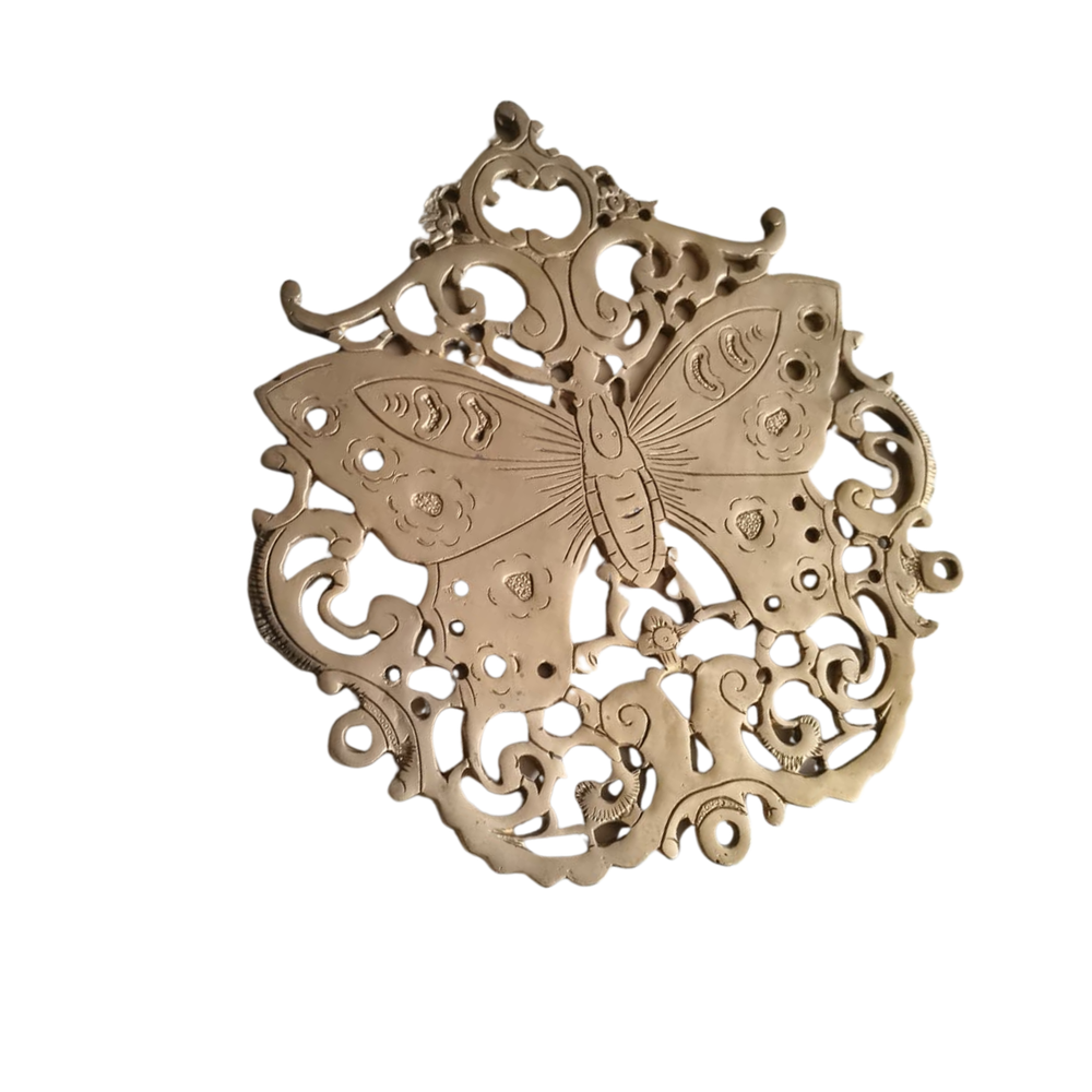 Vintage-style brass butterfly wall decor with intricate filigree medallion.