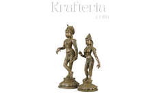 Rishaba Devar , Shiva parvati Panchaloha statues of a man and a woman on a white background with 'Krafteria' branding.
