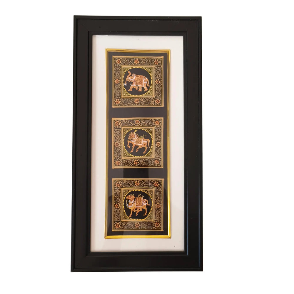 Framed artwork with three decorative panels featuring elephants on a white background