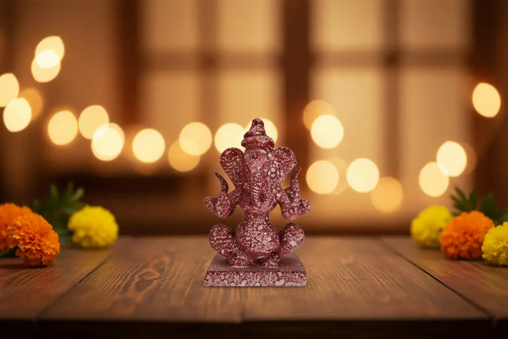 Double-sided Lord Ganesha statue made from polished red marble.