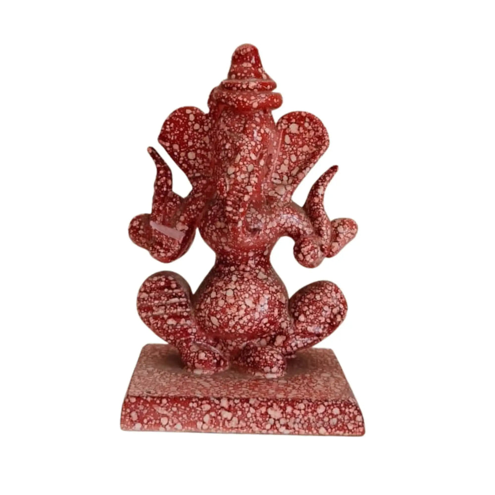 Artisan-made red marble Ganesha murti with intricate detailing.