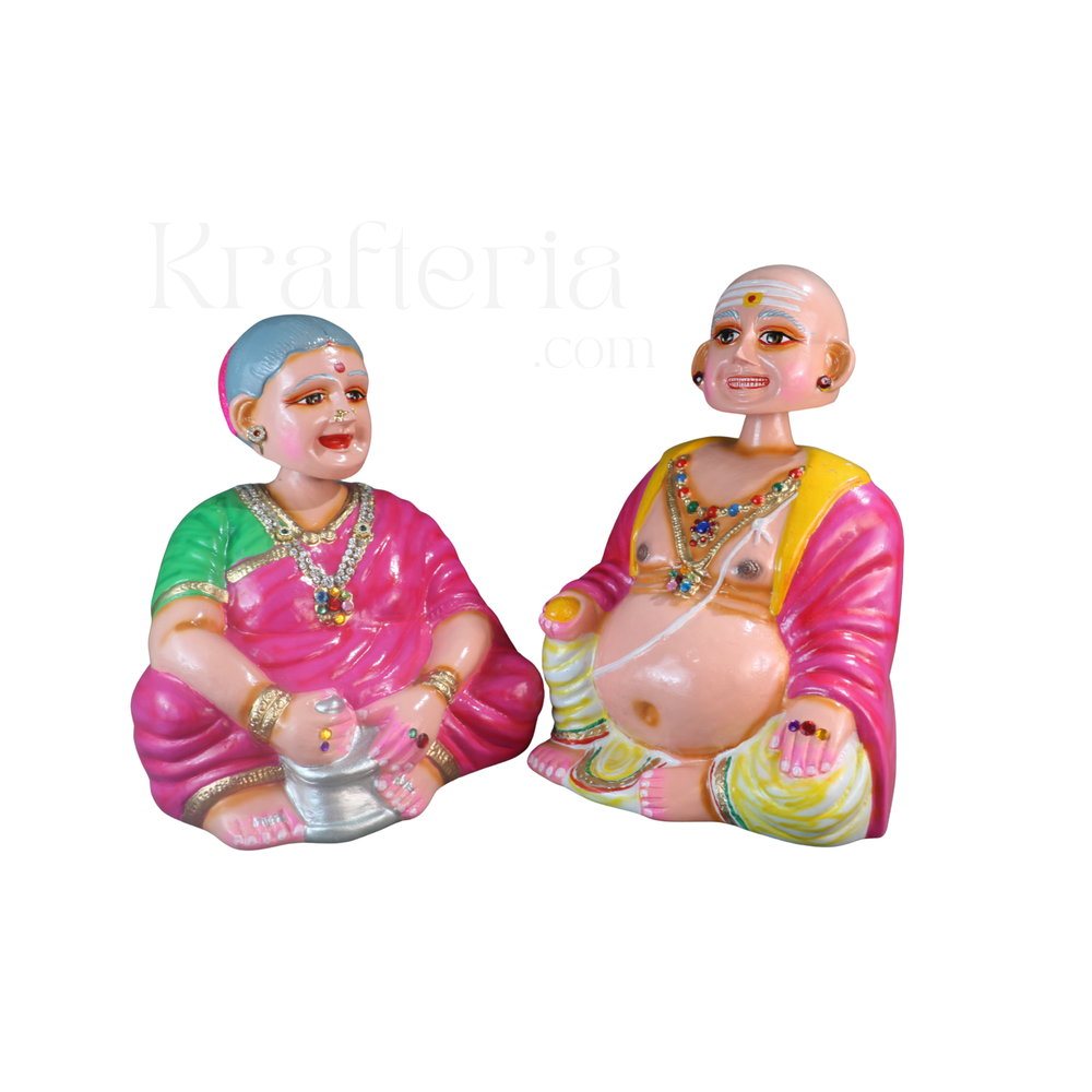 Paper macche Thalayatti Bommai Colorful figurines of elderly people on a white background