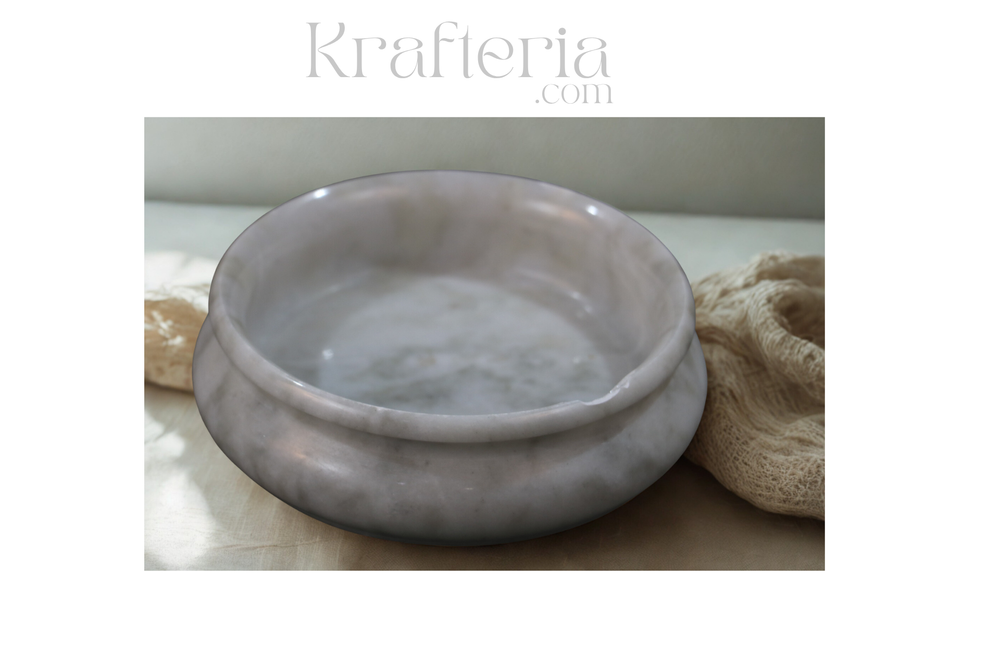 Marble-patterned ceramic bowl on a neutral background with 'Krafteria' branding.