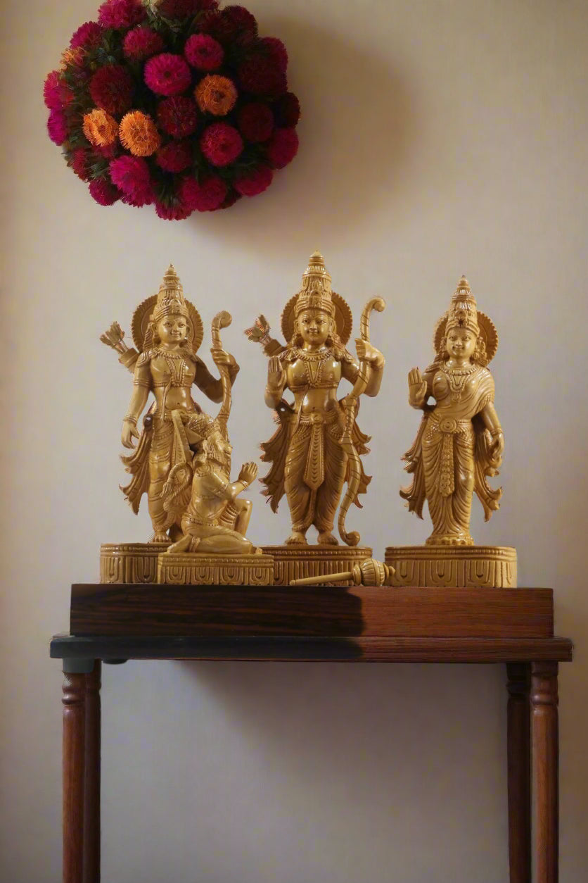 Wooden sculpture of three figures on a decorative stand with 'Krafteria' branding.