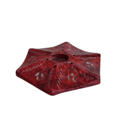 Decorative red stone incense holder with smooth finish.