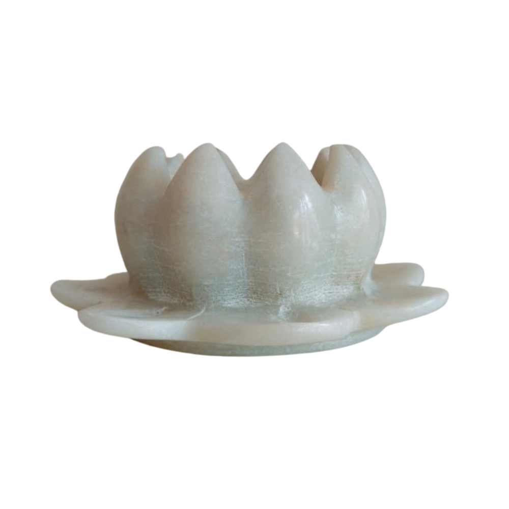 Minimalist white marble lotus accent for meditation space.