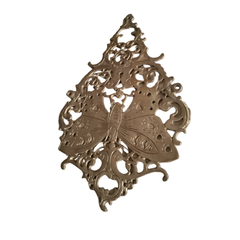 Vintage-style brass butterfly wall decor, intricate filigree medallion design.