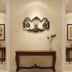 An ornate brass wall hanging displaying the U-shaped Venkateswara Namam (tilak) in the center, flanked by the Shankha (conch) and Chakra (discus) symbols, with decorative border work.