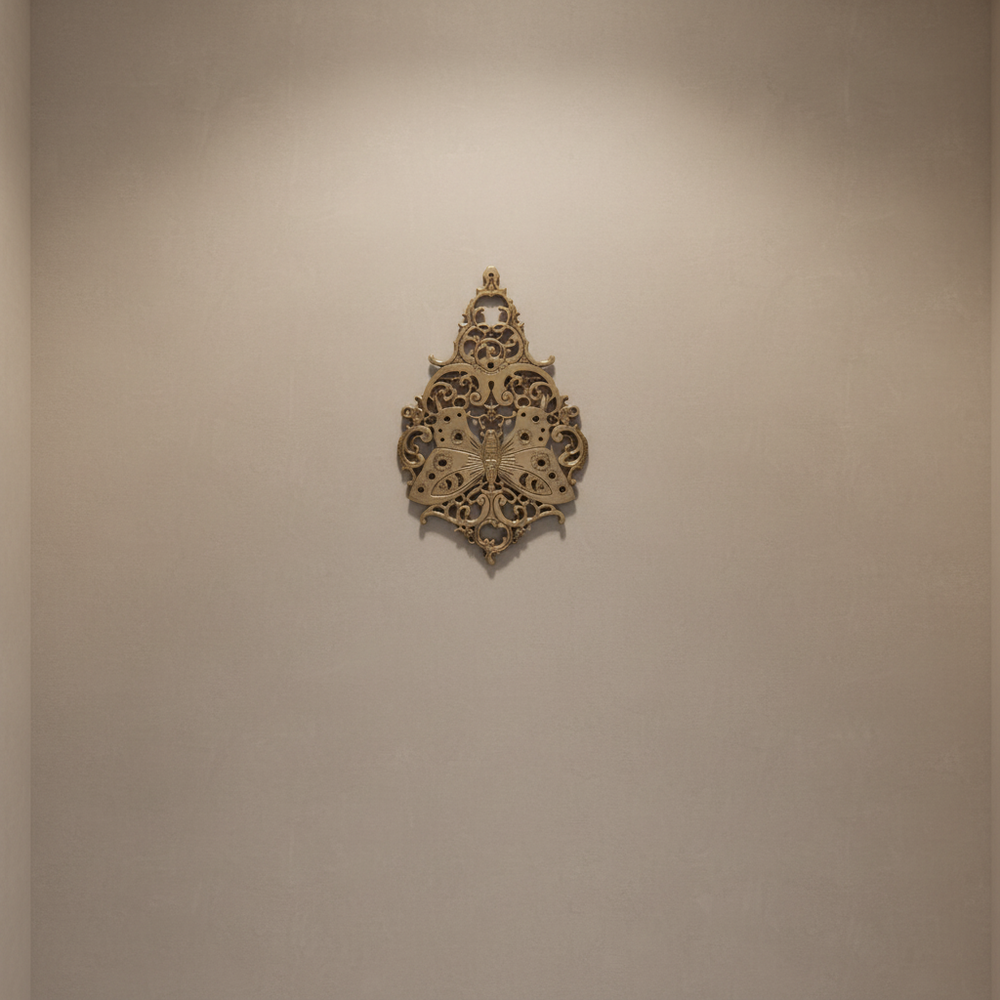 Vintage brass butterfly wall decor with intricate filigree medallion design.