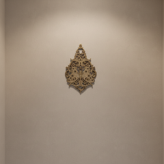 Vintage brass butterfly wall decor with intricate filigree medallion design.