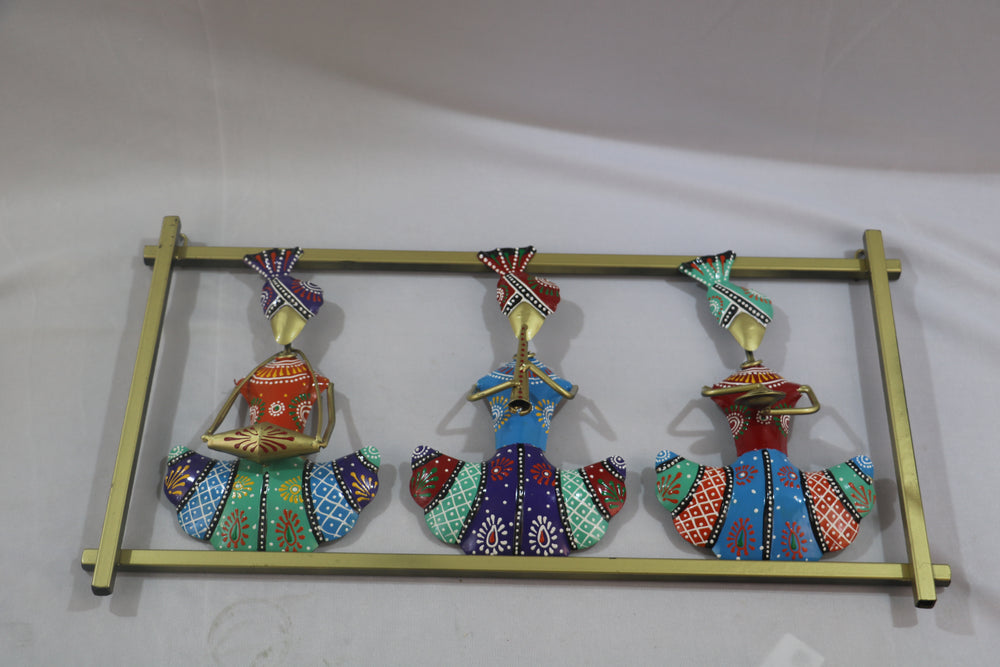 Decorative wall art with colorful figures on a gold stand against a white background