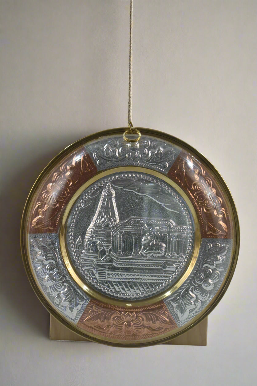 Decorative plate with intricate designs on a plain background