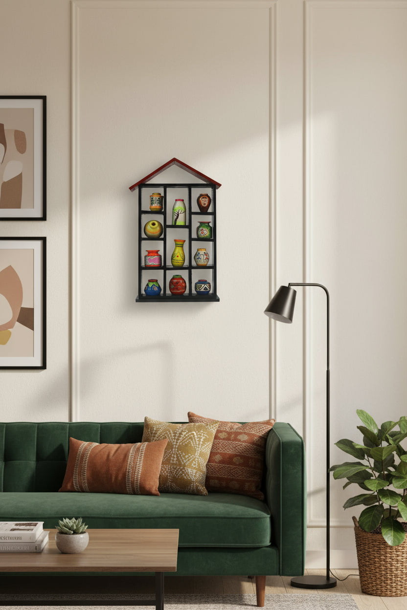 Decorative shelf with colorful vases against a pink background