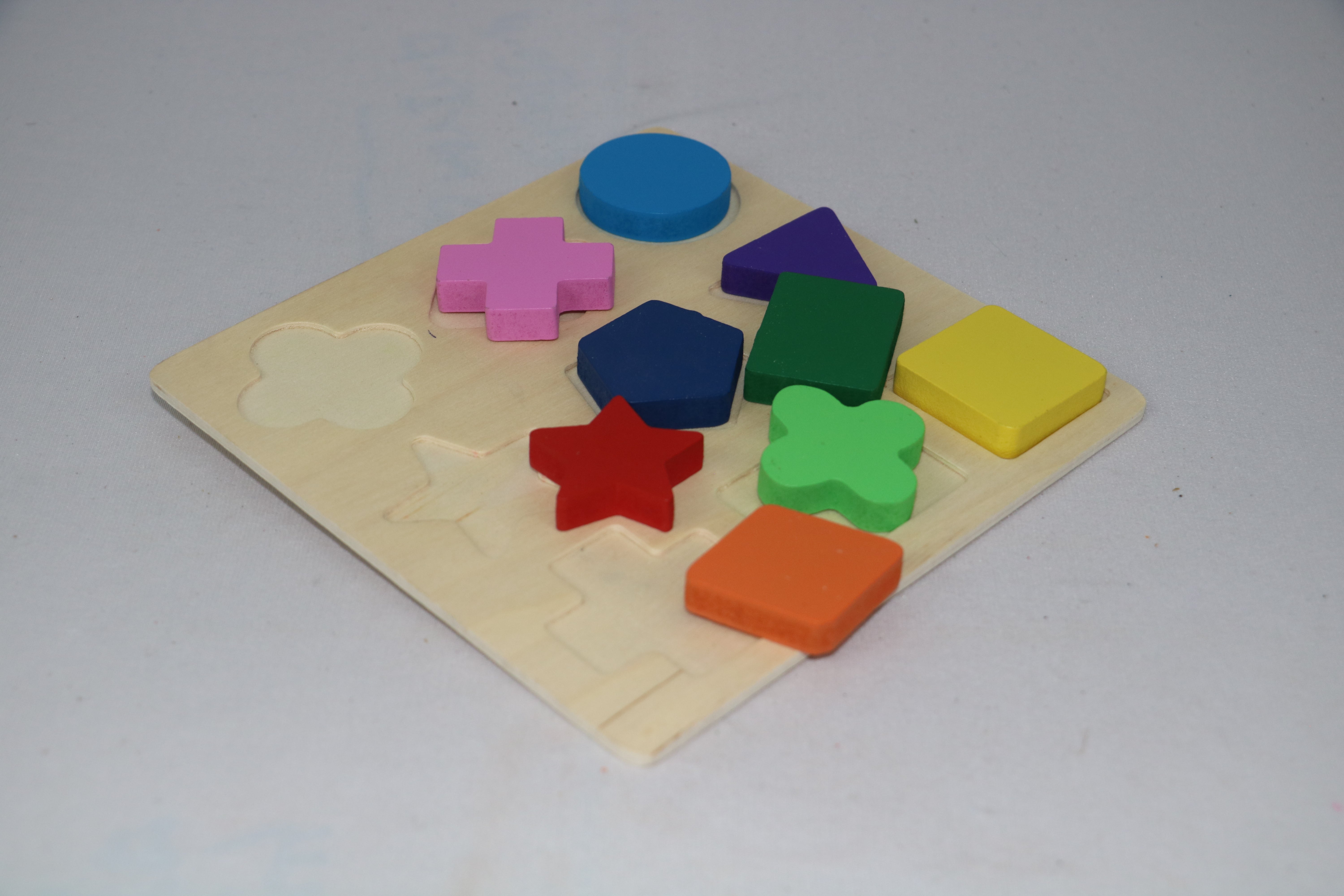 Colorful wooden shape puzzle on a light gray background