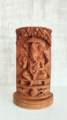 Intricate Cylindrical Wooden Carving with Ganesha and Sacred Cow Scenes