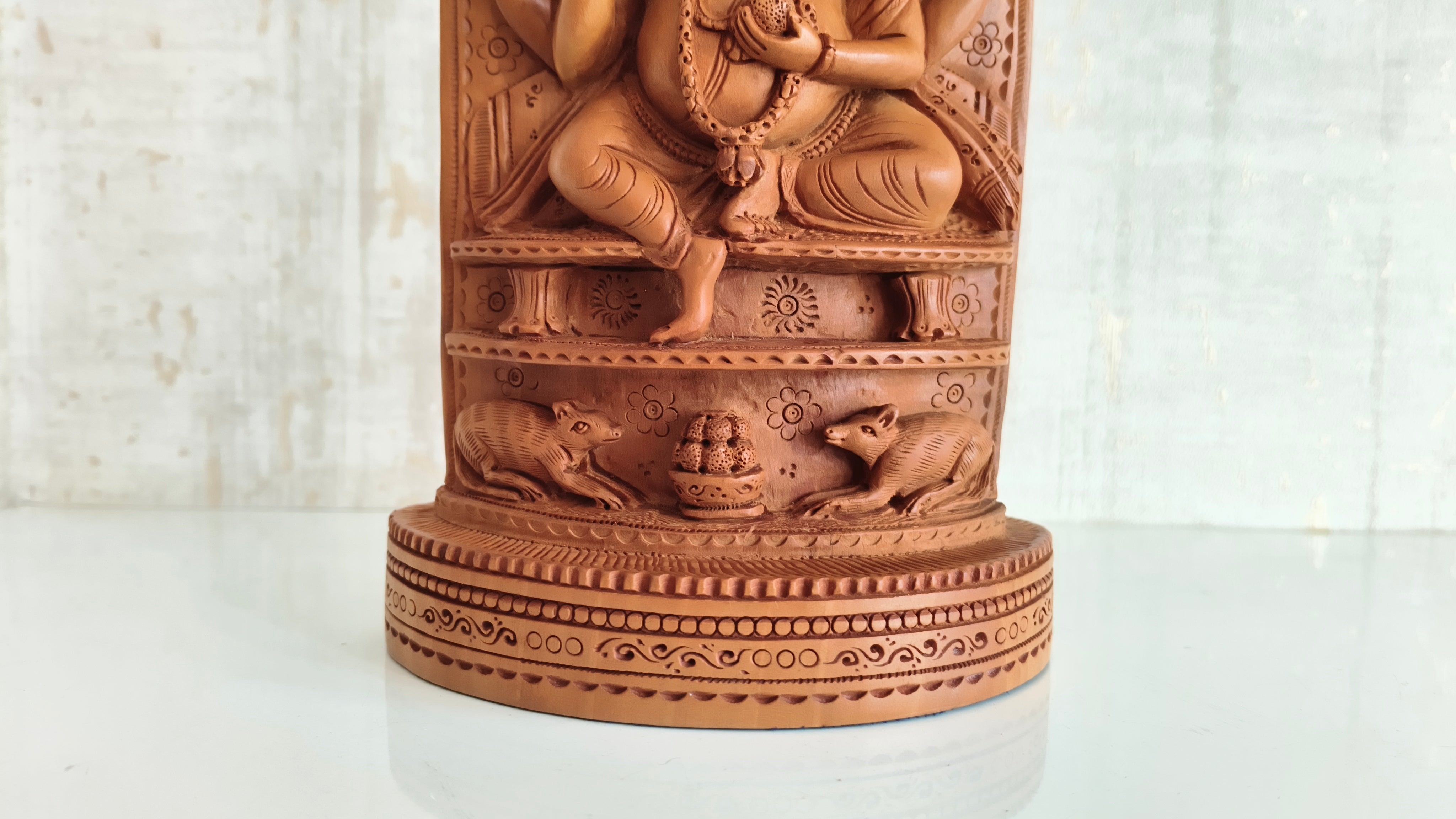 Intricate Cylindrical Wooden Carving with Ganesha and Sacred Cow Scenes