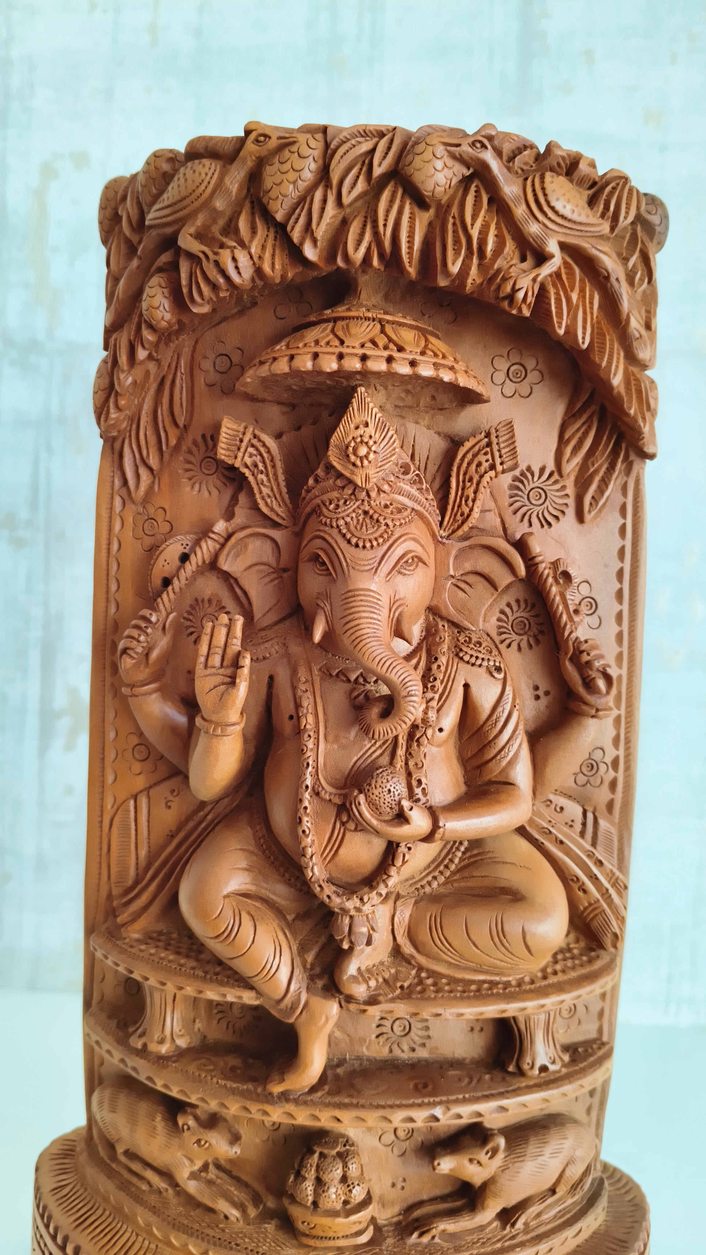 Intricate Cylindrical Wooden Carving with Ganesha and Sacred Cow Scenes