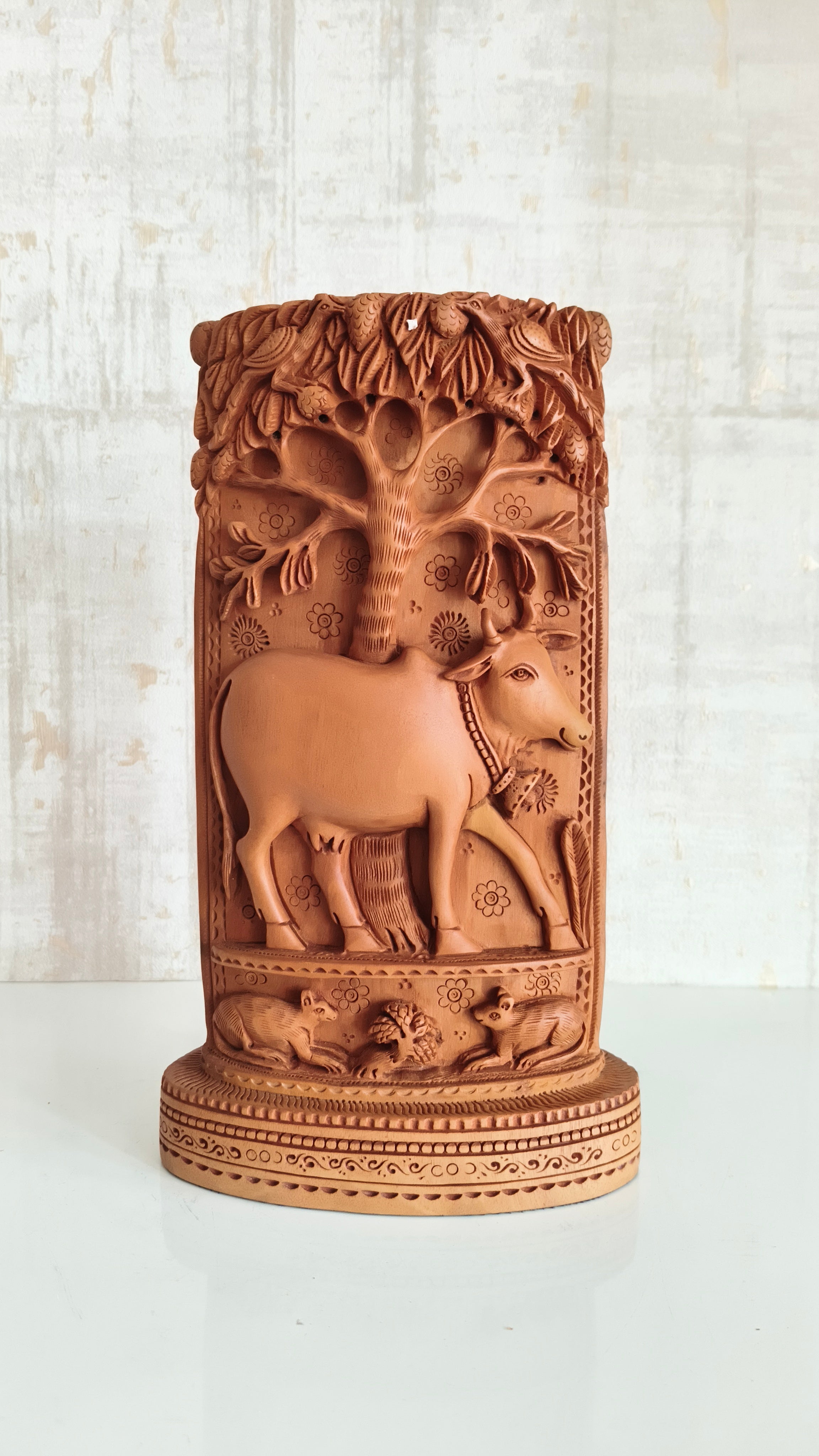 Intricate Cylindrical Wooden Carving with Ganesha and Sacred Cow Scenes