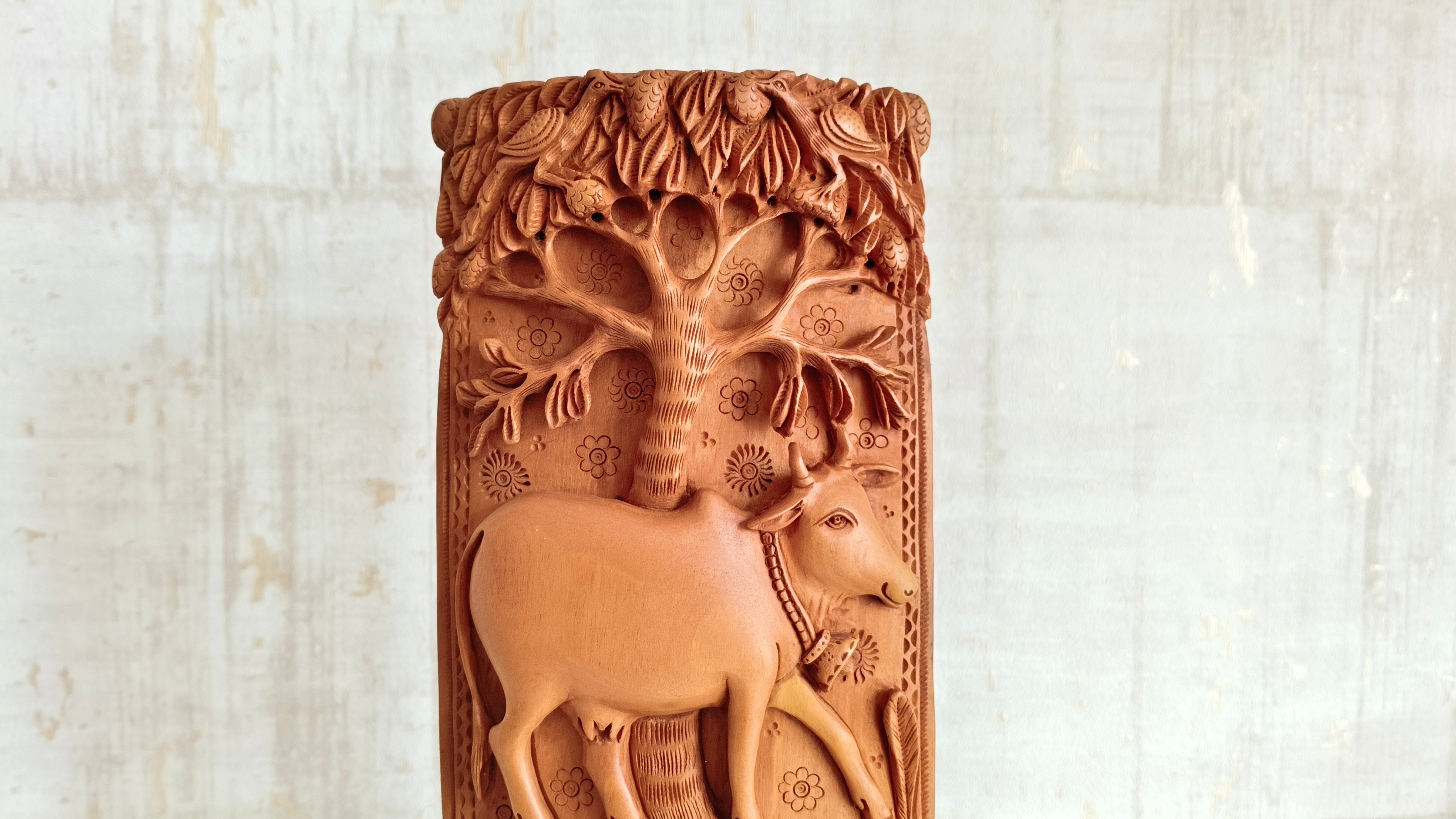 Intricate Cylindrical Wooden Carving with Ganesha and Sacred Cow Scenes