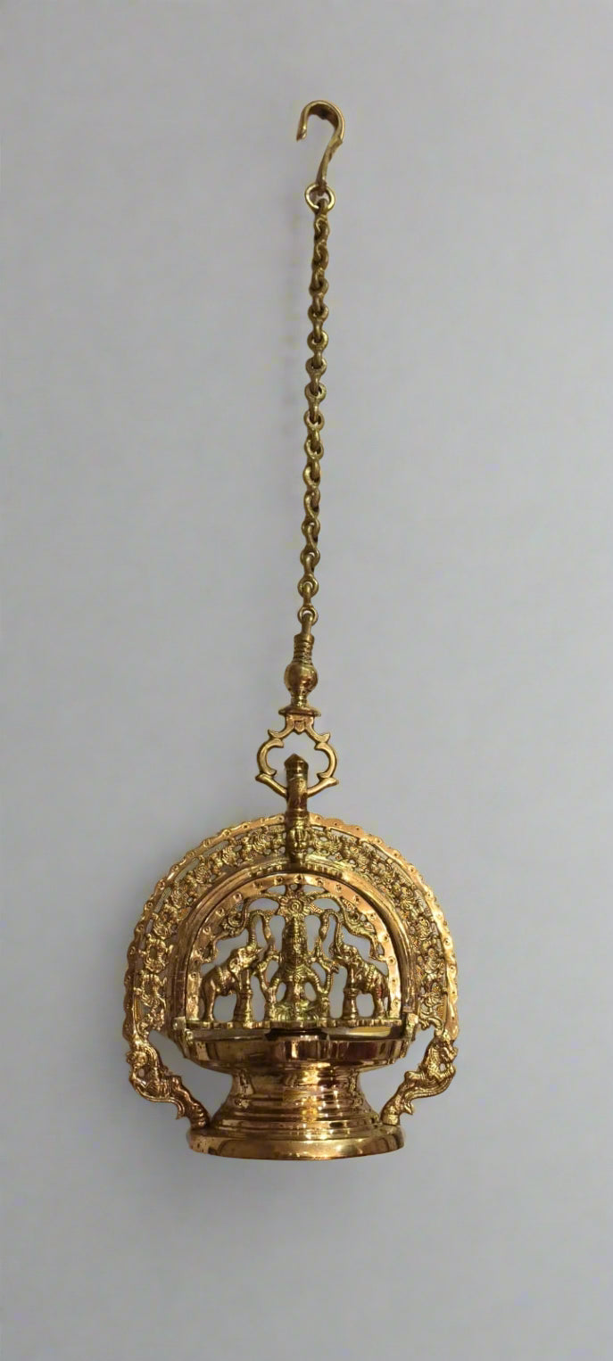 Decorative gold hanging object on a gray background