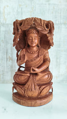 Reversible hand-carved wooden statue depicting a meditating Buddha on one side and an intricate Bodhi Tree design on the other, against a light background.