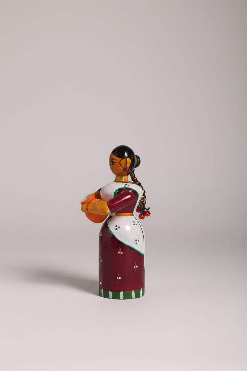Handmade Etikoppaka wooden doll, a colorful traditional craft for home decor and gifts.