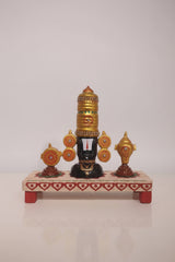 Lord Venkateswara wooden altar with golden crown, conch, and chakra wheels on a decorated base