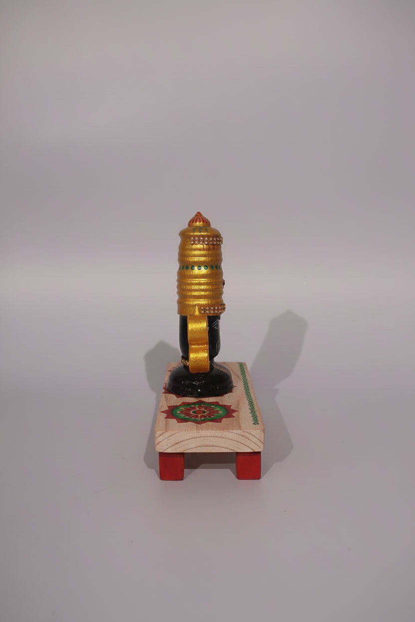 Lord Venkateswara wooden altar with golden crown, conch, and chakra wheels on a decorated base