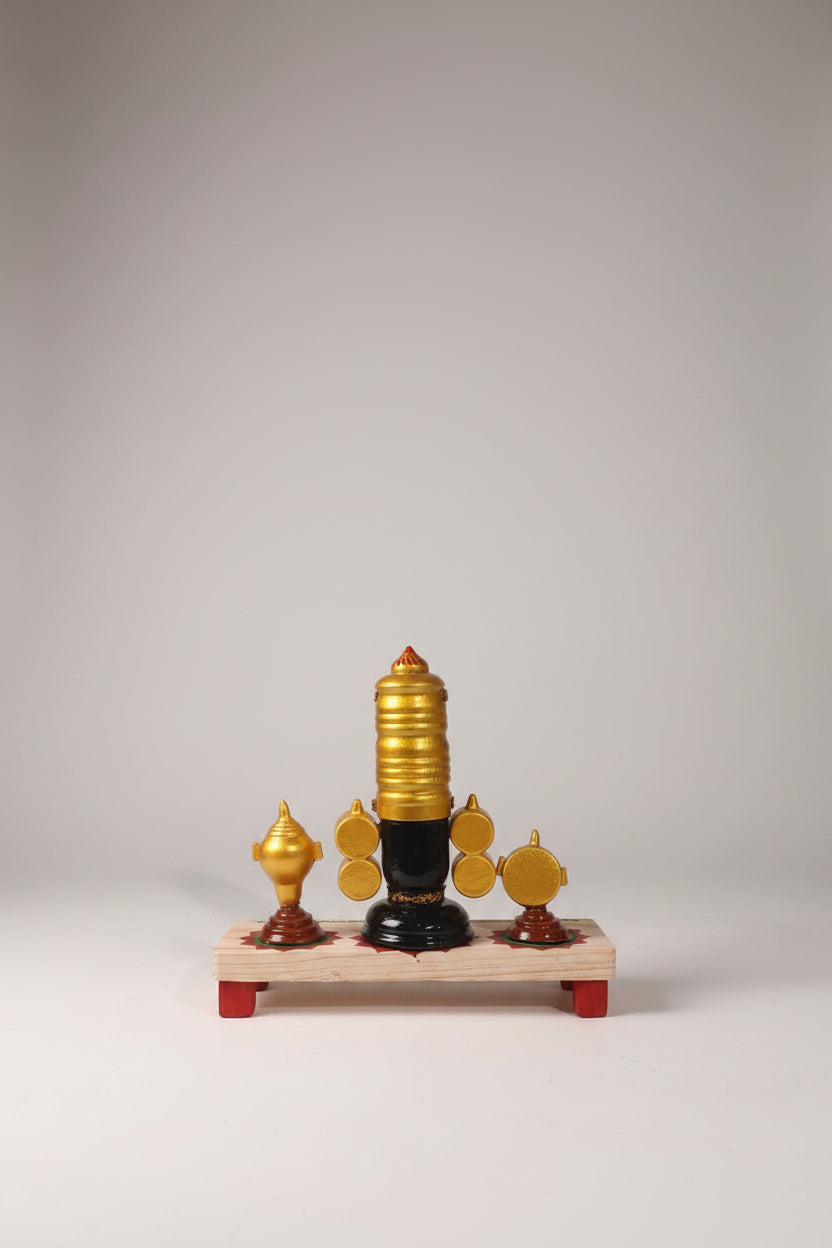 Lord Venkateswara wooden altar with golden crown, conch, and chakra wheels on a decorated base
