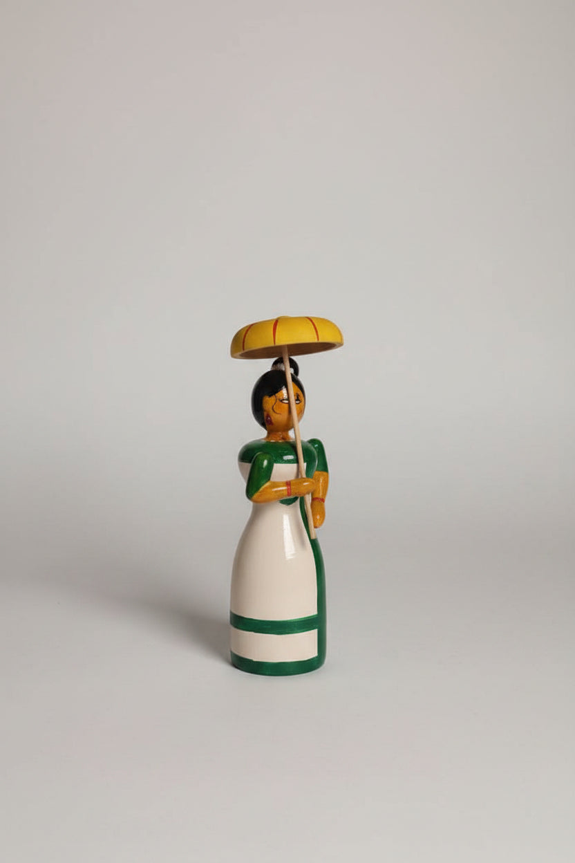 Traditional Etikoppaka wooden doll with umbrella, a charming home decor piece.