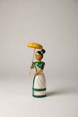 Traditional Etikoppaka wooden doll holding an umbrella, a vibrant home decor piece.