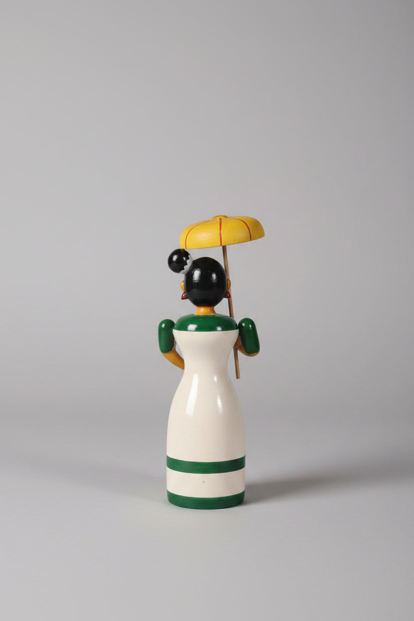 Traditional Etikoppaka wooden doll holding an umbrella, a charming piece of home decor.
